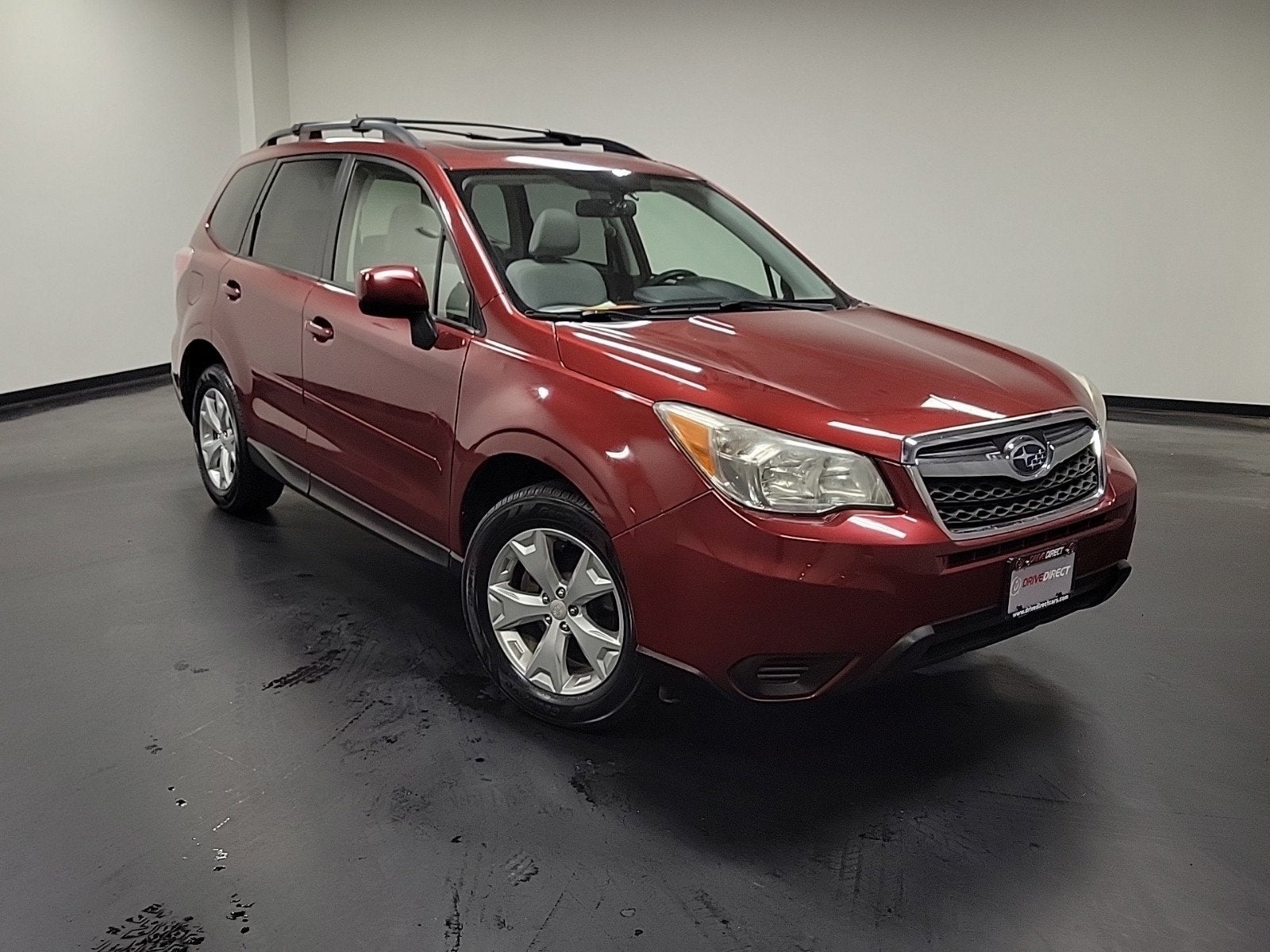 2014 Subaru Forester 2.5i Premium in Venetian Red Pearl — front three-quarter view