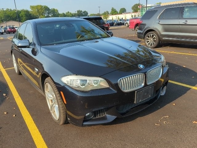 2011 BMW 5 Series 550i xDrive in Carbon Black Metallic — front three-quarter view