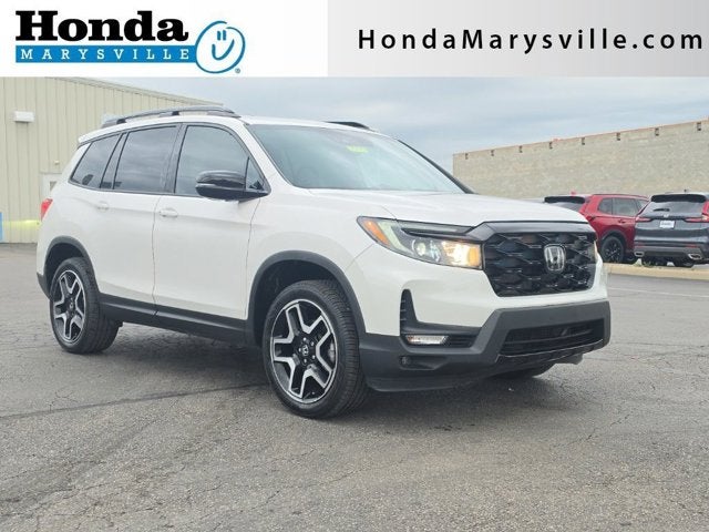 2023 Honda Passport Elite in Platinum White Pearl — front three-quarter view