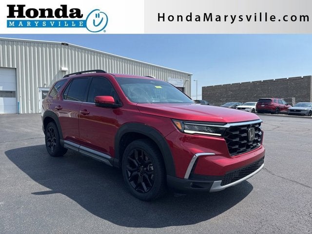 2025 Honda Pilot Elite in Radiant Red Metallic II — front three-quarter view