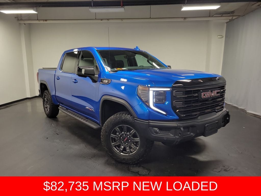 2024 GMC Sierra 1500 AT4X in Dynamic Blue Metallic — front three-quarter view