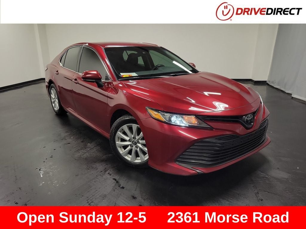 2018 Toyota Camry LE in Ruby Flare Pearl — front three-quarter view
